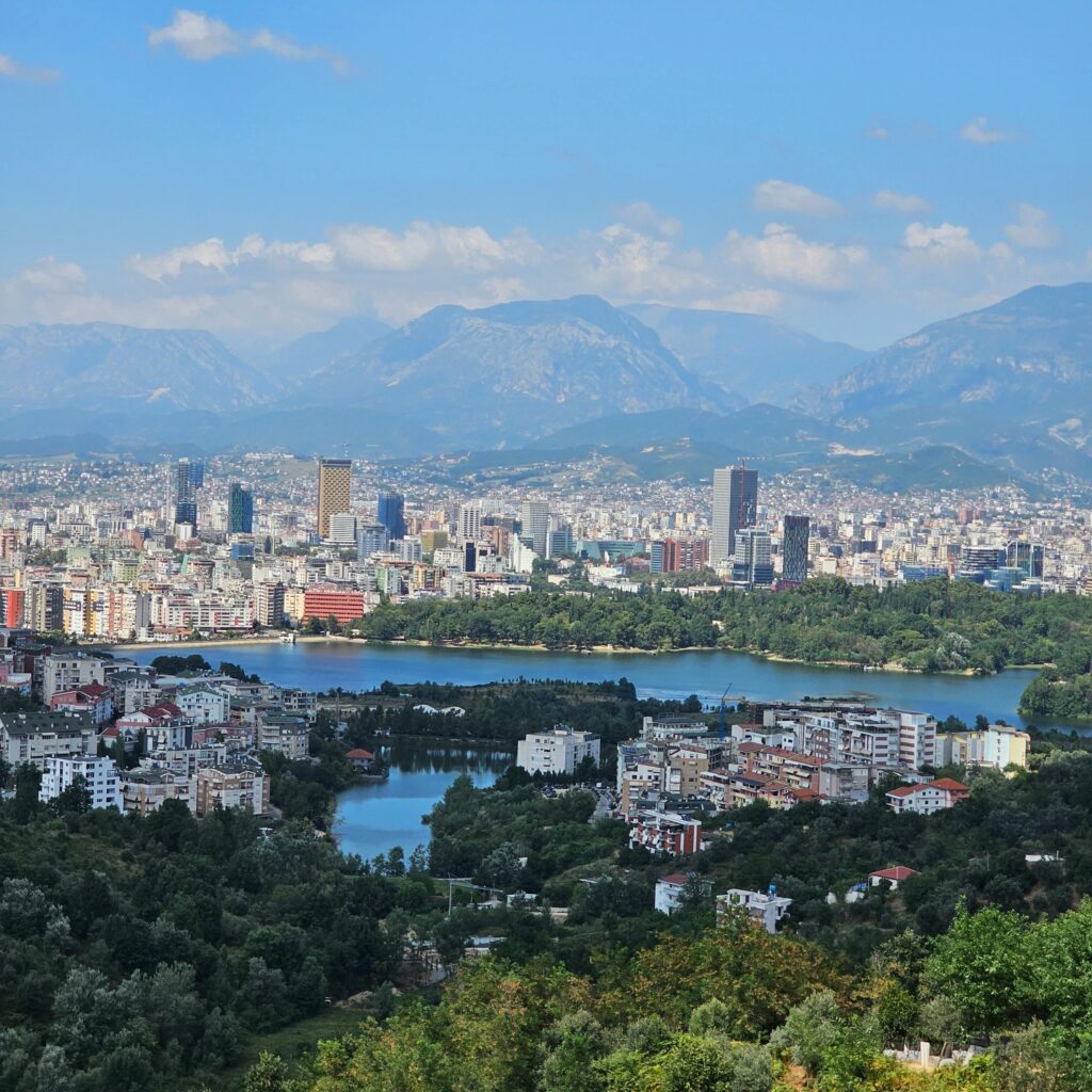 A picturesque aerial view of Tirana, Albania with mountains and urban landscape.