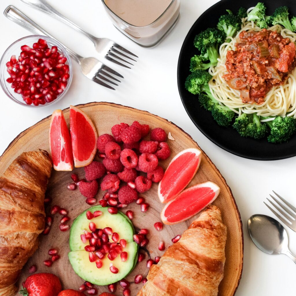 pexels-photo-793765-793765 A vibrant breakfast spread with croissants, pasta, and fresh fruits, perfect for food lovers.